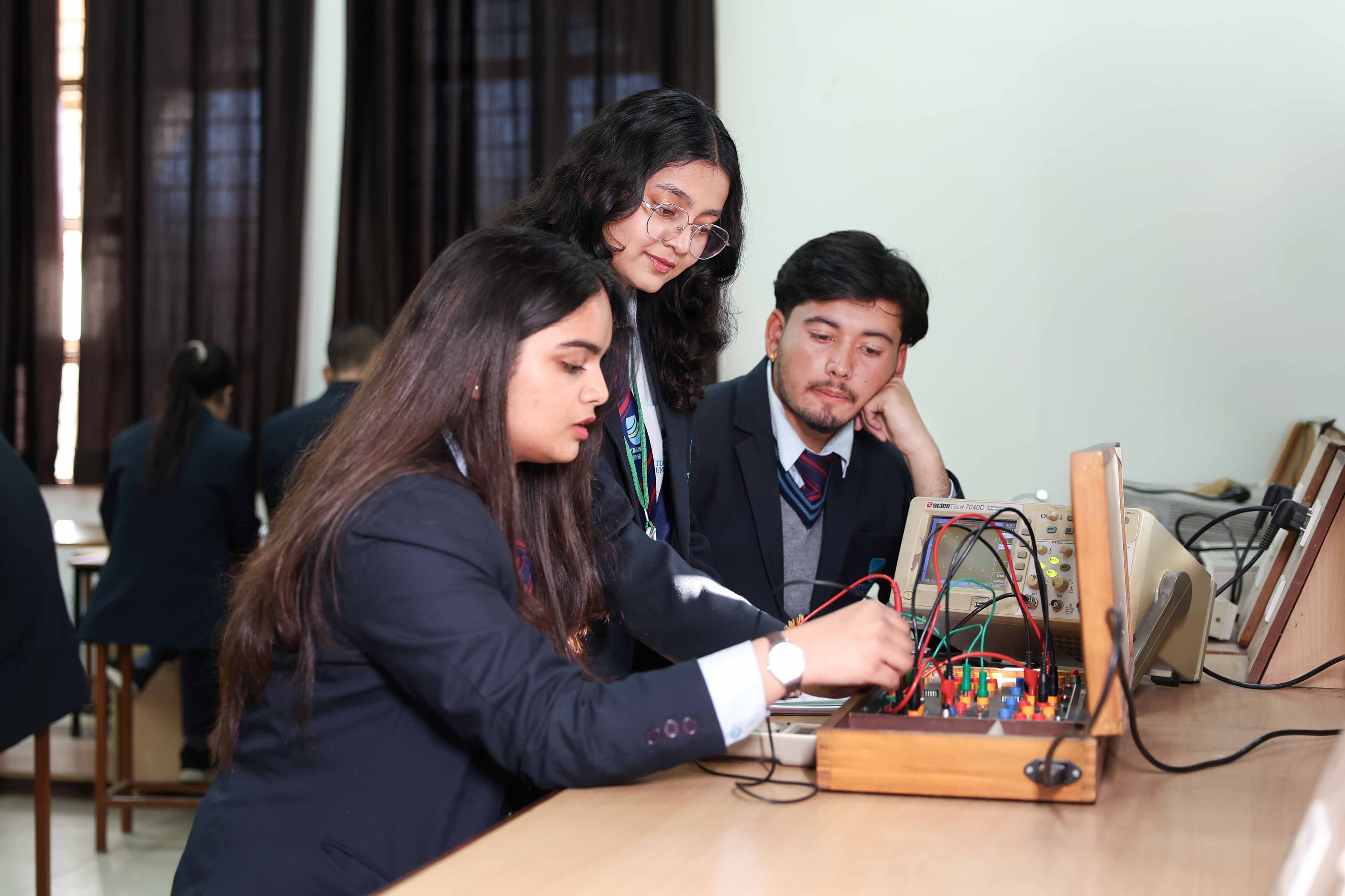 Students performing hands-on experiments in electronics lab
